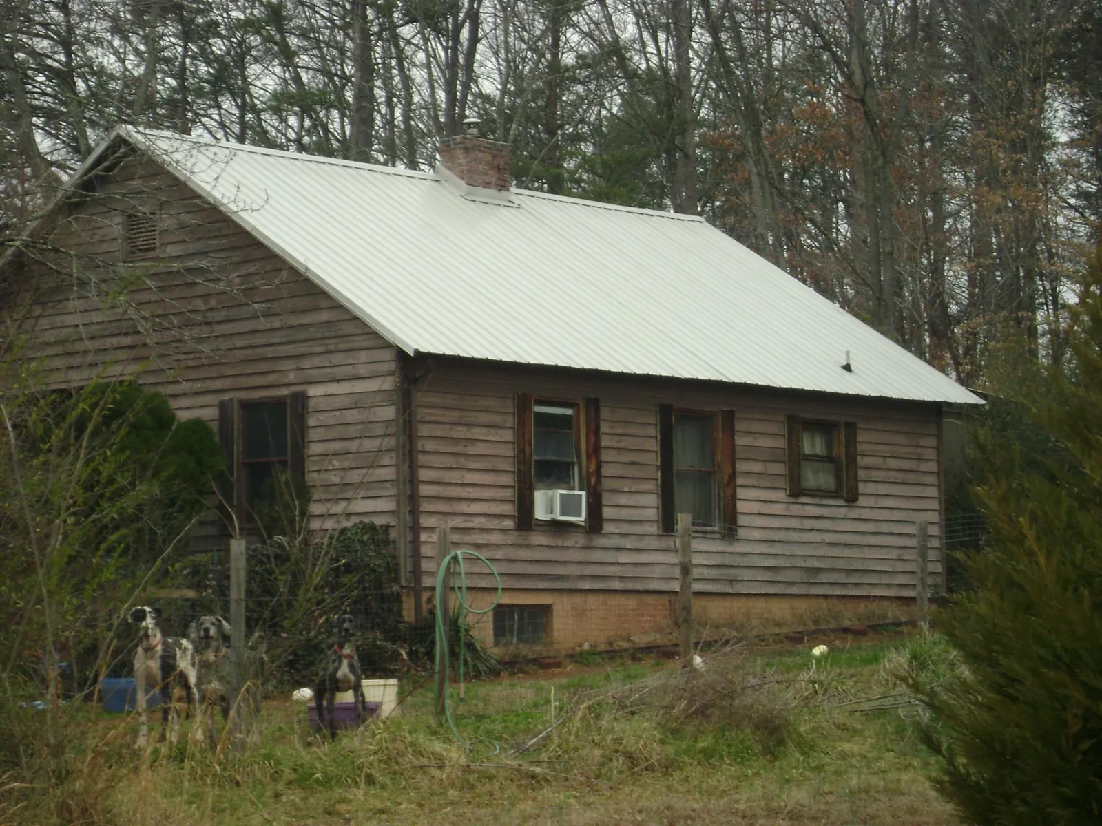 White metal roof on an old wood sided farmhouse, from a Asphalt Shingle Roof Repair job in Pawtucket